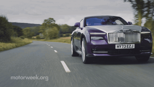 A Purple Car With The License Plate Hy73 Ezj Is Driving Down A Road GIF
