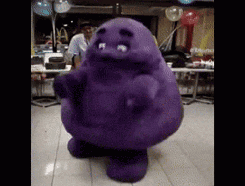 A Purple Cartoon Character Is Dancing In A Room With Balloons GIF