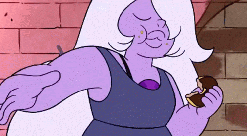 A Purple Cartoon Character Is Holding A Piece Of Chocolate GIF