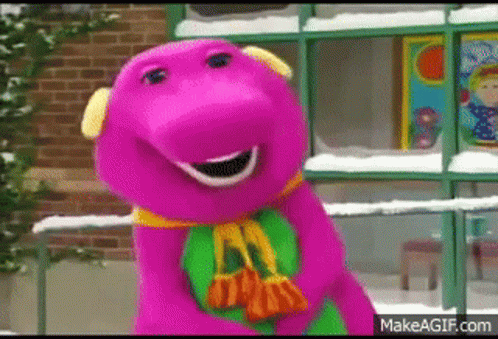 A Purple Dinosaur Is Standing In Front Of A Brick Building Holding A Bag . GIF