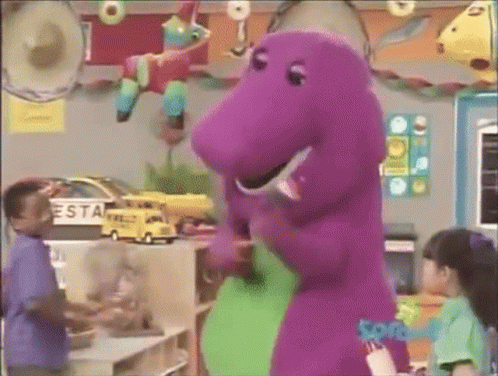 A Purple Dinosaur Is Standing Next To A Green Dinosaur In A Room With Children . GIF