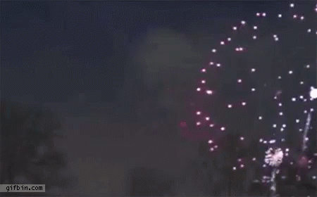 A Purple Fireworks Display In The Night Sky . GIF