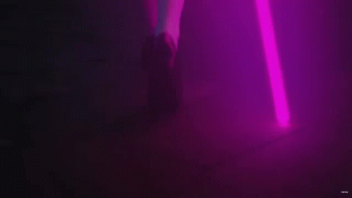 A Purple Light Beam Is Coming Out Of A Purple Object . GIF