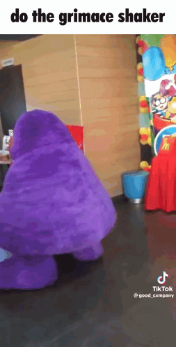 A Purple Mcdonald 'S Mascot Is Dancing In A Room With The Caption Do The Grimace Shaker GIF
