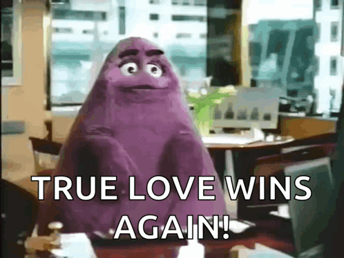 A Purple Monster Is Sitting At A Table With The Words `` True Love Wins Again '' . GIF