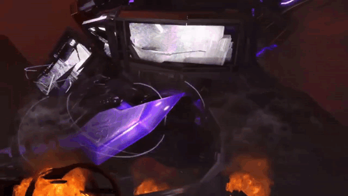 a purple object is surrounded by fire and smoke in a dark room