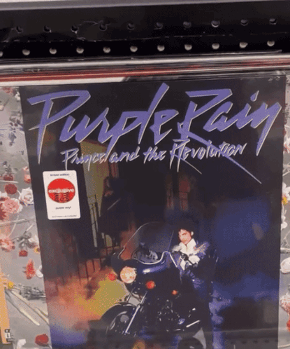 A Purple Rain Album Cover With A Man On A Motorcycle On It GIF