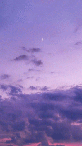 A Purple Sky With A Crescent Moon In The Foreground GIF