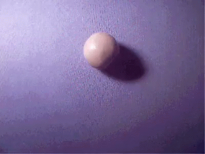 A Purple Surface With A White Ball On It GIF