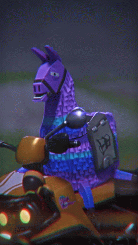 a purple toy llama is riding on the back of an orange vehicle