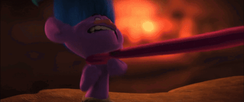 A Purple Troll With Blue Hair Is Holding A Pink Stick To His Neck . GIF