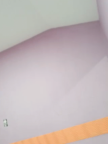 A Purple Wall With An Orange Stripe On The Bottom GIF