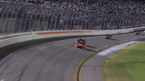 a race car is going around a curve in a race