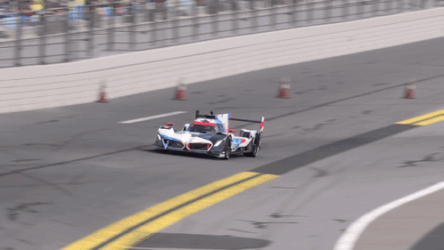 A Race Car Is Going Around A Curve On A Race Track GIF