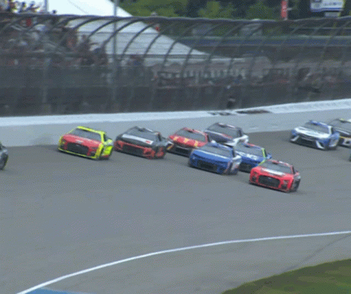 A Race Car With A Blue Stripe On The Side Is Driving Down A Track GIF