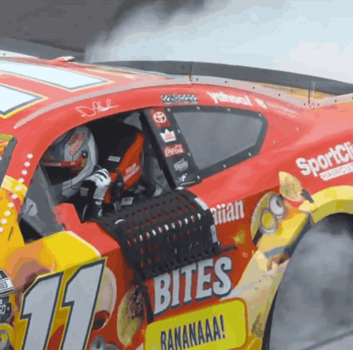 A Race Car With The Number 11 On The Side Of It GIF