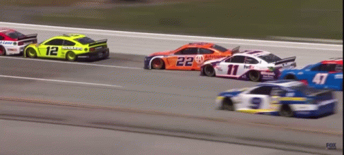 A Race Car With The Number 12 On The Side Of It GIF