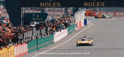 A Race Track With A Sign That Says Rolex In The Background GIF