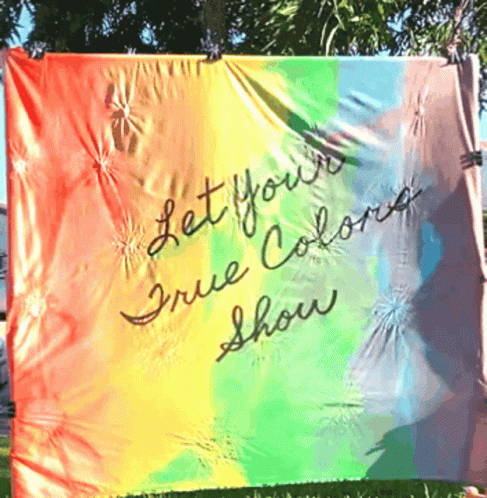 A Rainbow Flag With The Words " Let Your True Colors Show " Written On It GIF