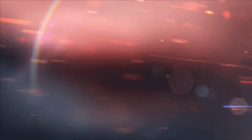 A Rainbow Is Visible In The Middle Of A Dark Background GIF