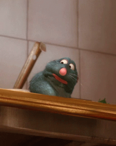 A Rat With A Pink Nose Is Sitting On A Wooden Shelf GIF