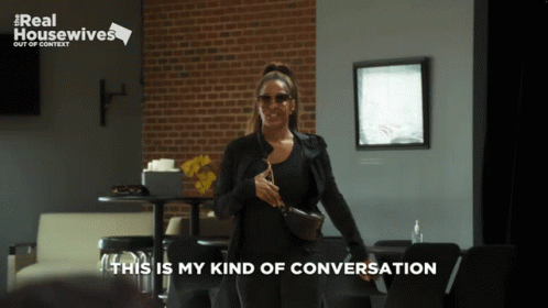 A Real Housewives Advertisement Shows A Woman Standing In A Restaurant GIF