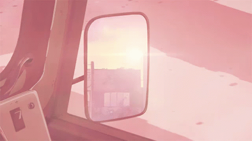 A Rear View Mirror In A Pink Car Shows A Sunset GIF