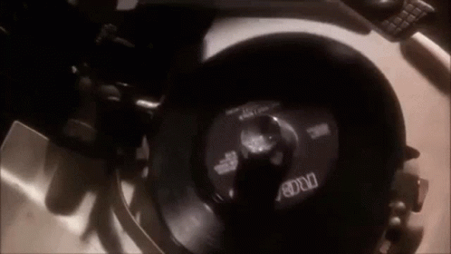 A Record Player Is Playing A Record On A Turntable . GIF