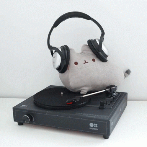 A Record Player With Headphones And A Stuffed Cat On It GIF