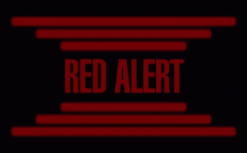 a red alert sign is displayed on a black background with red lines .
