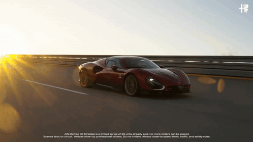 A Red Alfa Romeo Car Is Driving Down A Highway At Sunset GIF