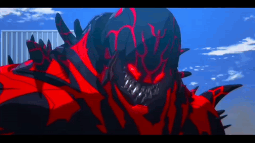 A Red And Black Monster With Sharp Teeth Is Standing In Front Of A Building GIF