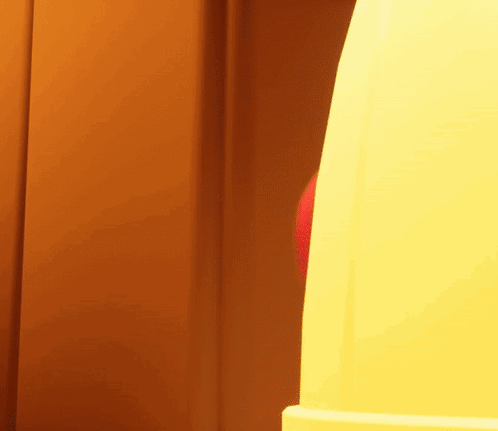A Red And Blue Balloon Is Being Thrown Into A Yellow Object GIF