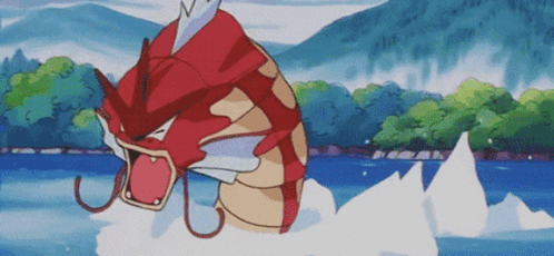 A Red And Gold Fish Is Swimming In A Lake GIF