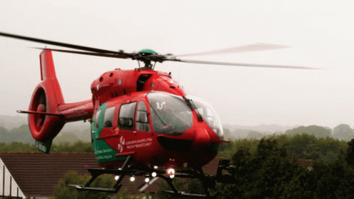 A Red And Green Helicopter With The Word Northern Ireland On The Side GIF