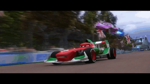 A Red And Green Race Car Is On A Track GIF