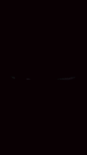A Red And Purple Eye On A Black Background GIF