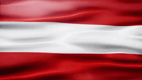 A Red And White Flag Is Waving In The Wind .. GIF