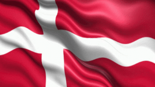A Red And White Flag With A Cross On It Is Waving In The Wind GIF