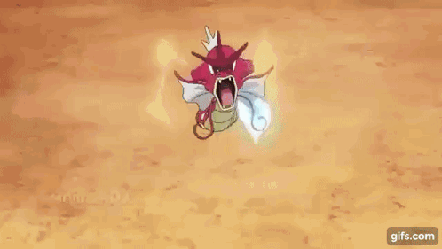 A Red And White Pokemon With Its Mouth Open Is Holding A Blue Flame In Its Mouth . GIF