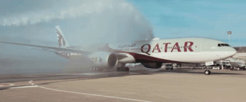 A Red And White Qatar Airplane Is Parked On The Runway GIF