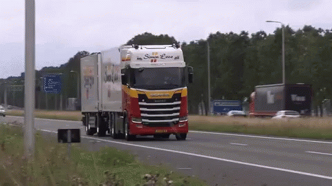 A Red And White Truck With The Word Scania On The Side GIF