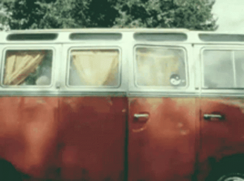 A Red And White Van Is Parked In Front Of A Tree GIF