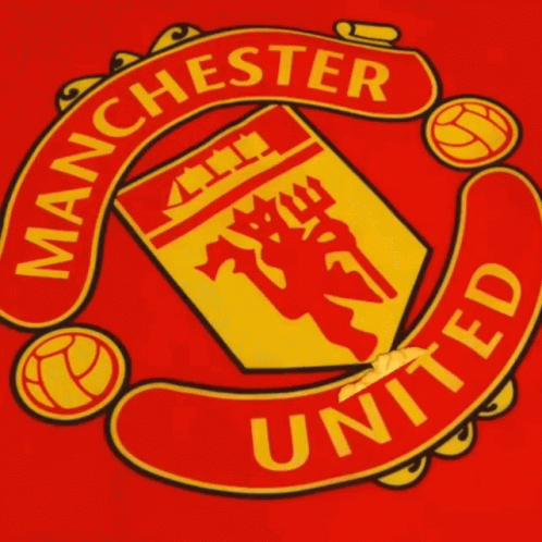 A Red And Yellow Manchester United Logo With A Finger Pointing At It GIF