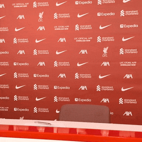 A Red Backdrop With Nike And Expedia Written On It GIF
