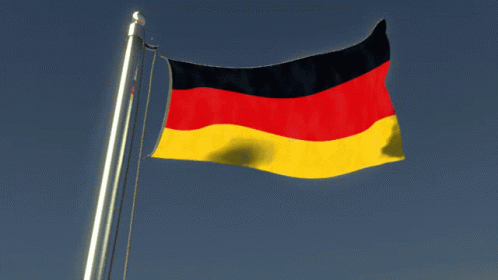 A Red Black And Yellow Flag Is Waving In The Wind GIF