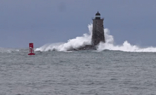 A Red Buoy With The Letter N On It Is In The Middle Of The Ocean Near A Lighthouse GIF