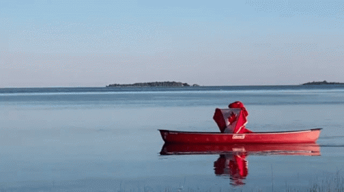 a red canoe with a canadian flag on top of it