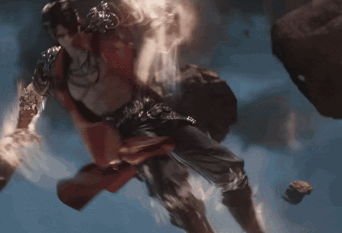 a red cape is flying through the air with a light coming from it