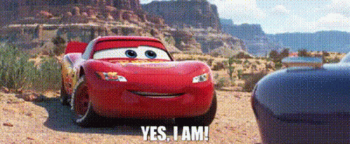 A Red Car From The Movie Cars Is Driving Down A Dirt Road And Says `` Yes , I Am '' . GIF